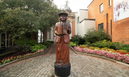 Tree sculpture of woman with book